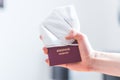 Passport pandemic vacation concept: Close up of fingers holding a passport, ffp2 protection mask, Ã¢â¬ÅReisepass Passport